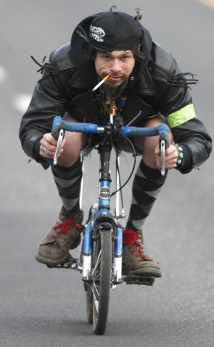 Dan Oviatt, known as "Captain America," rides his mini bike during a three-day Mini Bike Winter Olympics Sunday, Feb.19, 2012, in Portland, Ore. “Zoobombers” are known for riding pint-sized kids’ bikes at breakneck speed down steep streets in Portland. (AP Photo/Rick Bowmer)