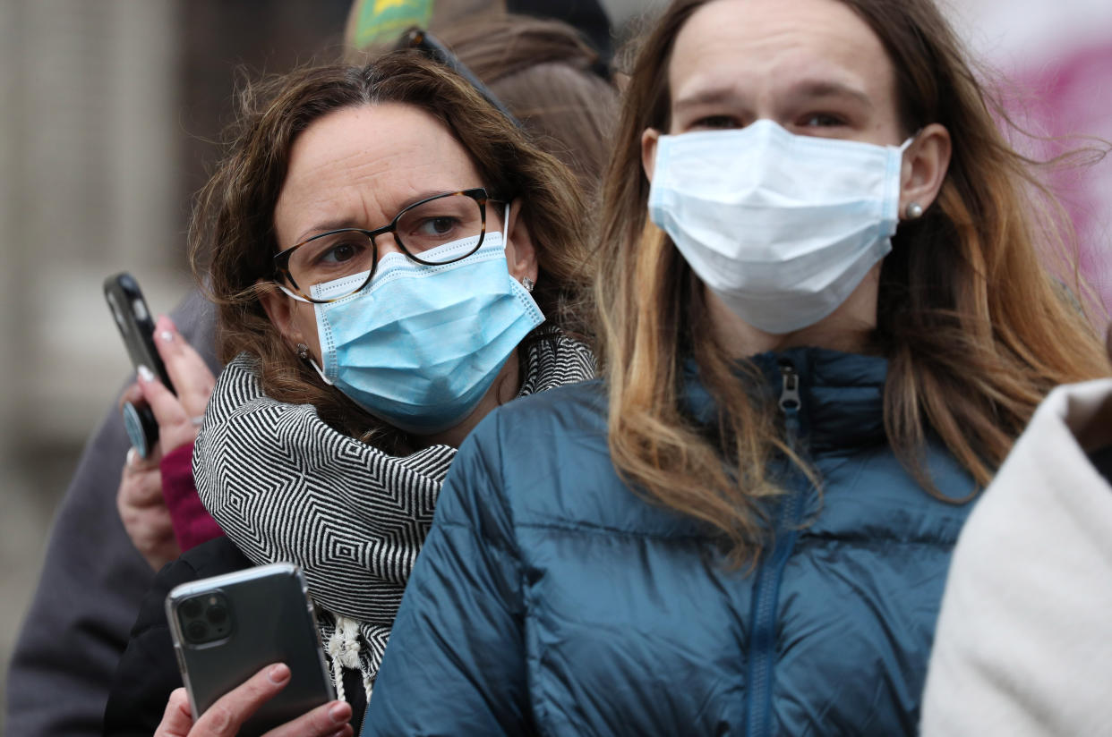 Spectators wearing masks to protect against coronavirus outside the Commonwealth Service at Westminster Abbey, London on Commonwealth Day. The service is the Duke and Duchess of Sussex's final official engagement before they quit royal life. (Photo by Jonathan Brady/PA Images via Getty Images)