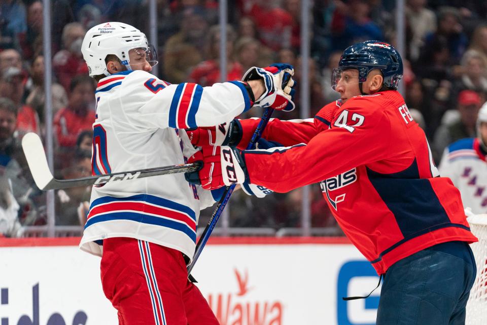 New York Rangers left wing Will Cuylle (50) and Washington Capitals defenseman Martin Fehervary (42) scuffle during the second period of an NHL hockey game, Saturday, Dec. 9, 2023, in Washington.