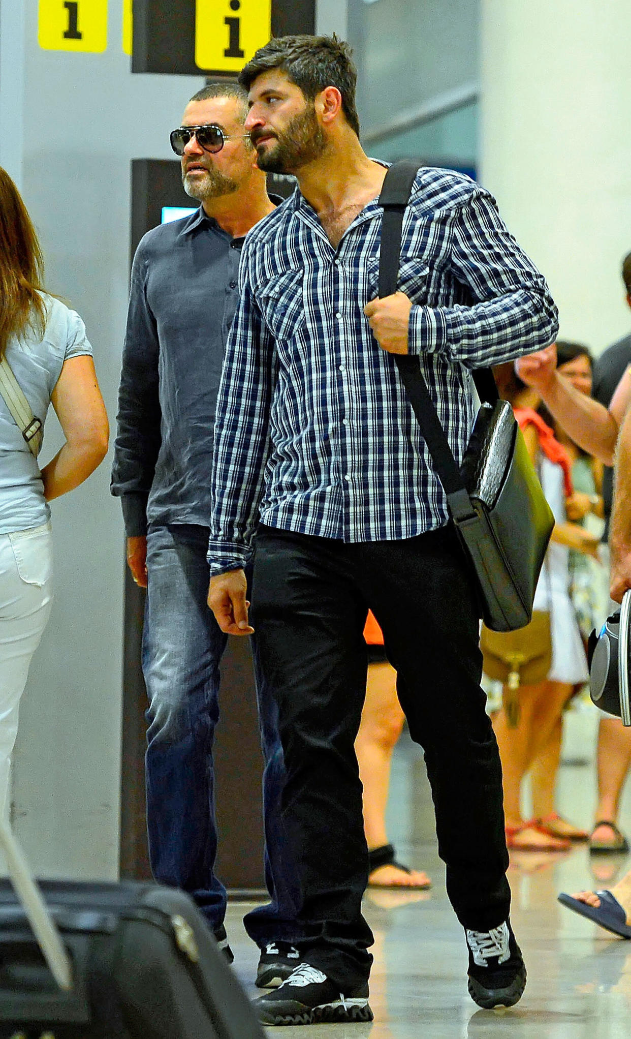 George Michael and his boyfriend Fadi Fawaz are seen at Barcelona El Prat Airport on July 29, 2012 