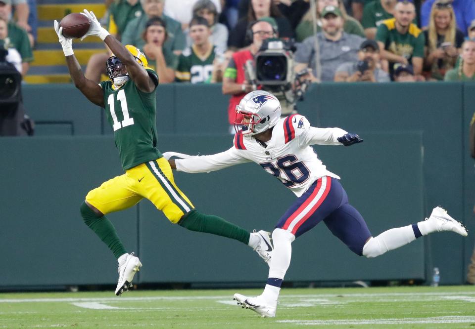 Green Bay Packers wide receiver Jayden Reed (11) pulls down a touchdown reception against New England Patriots cornerback Shaun Wade (26) during their preseason football game Saturday, August 19, 2023, at Lambeau Field in Green Bay, Wis. 
Dan Powers/USA TODAY NETWORK-Wisconsin.