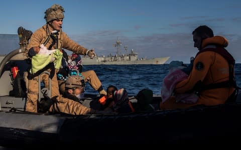 Spanish soldiers assist 329 refugees and migrants, mostly from Eritrea and Bangladesh, in collaboration with aid workers of the Spanish NGO Proactiva Open Arms, after they left Libya trying to reach European soil aboard an overcrowded wooden boat, 45 miles north of Al-Khums, Libya, January 2018. - Credit: AP