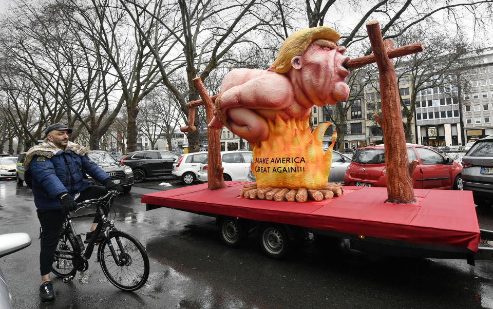 A political carnival float depicting former US president Donald Trump is pulled through the streets in Duesseldorf, Germany, Monday, Feb. 15, 2021. Because of the coronavirus pandemic the traditional; carnival parades are canceled but eight floats are pulled through the empty streets in Duesseldorf, where normally hundreds of thousands of people would celebrate the street carnival. (AP Photo/Martin Meissner)