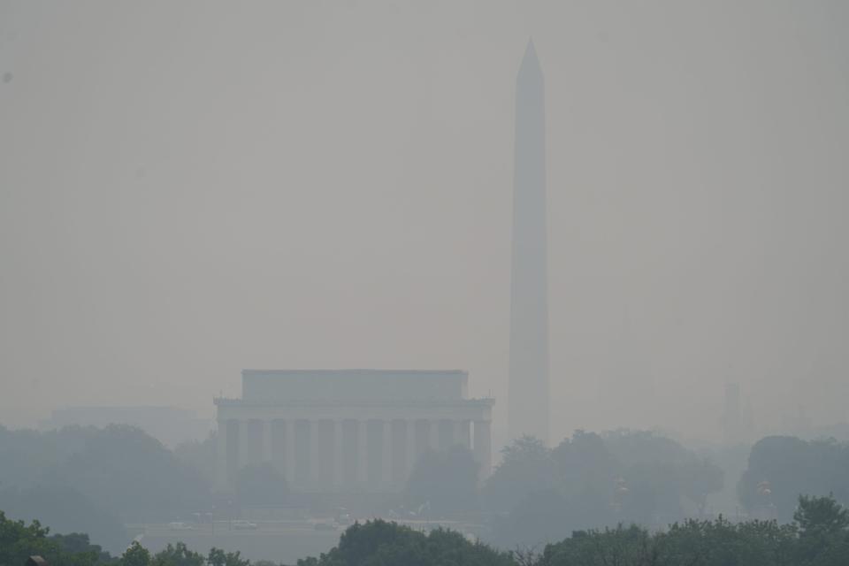 Smoke and haze caused by the wildfires in Canada is seen over Washington from Arlington, Va. Authorities warned residents across much of the Northeast to stay inside and limit or avoid outdoor activities, extending "Code Red" alerts in some places for a third straight day.