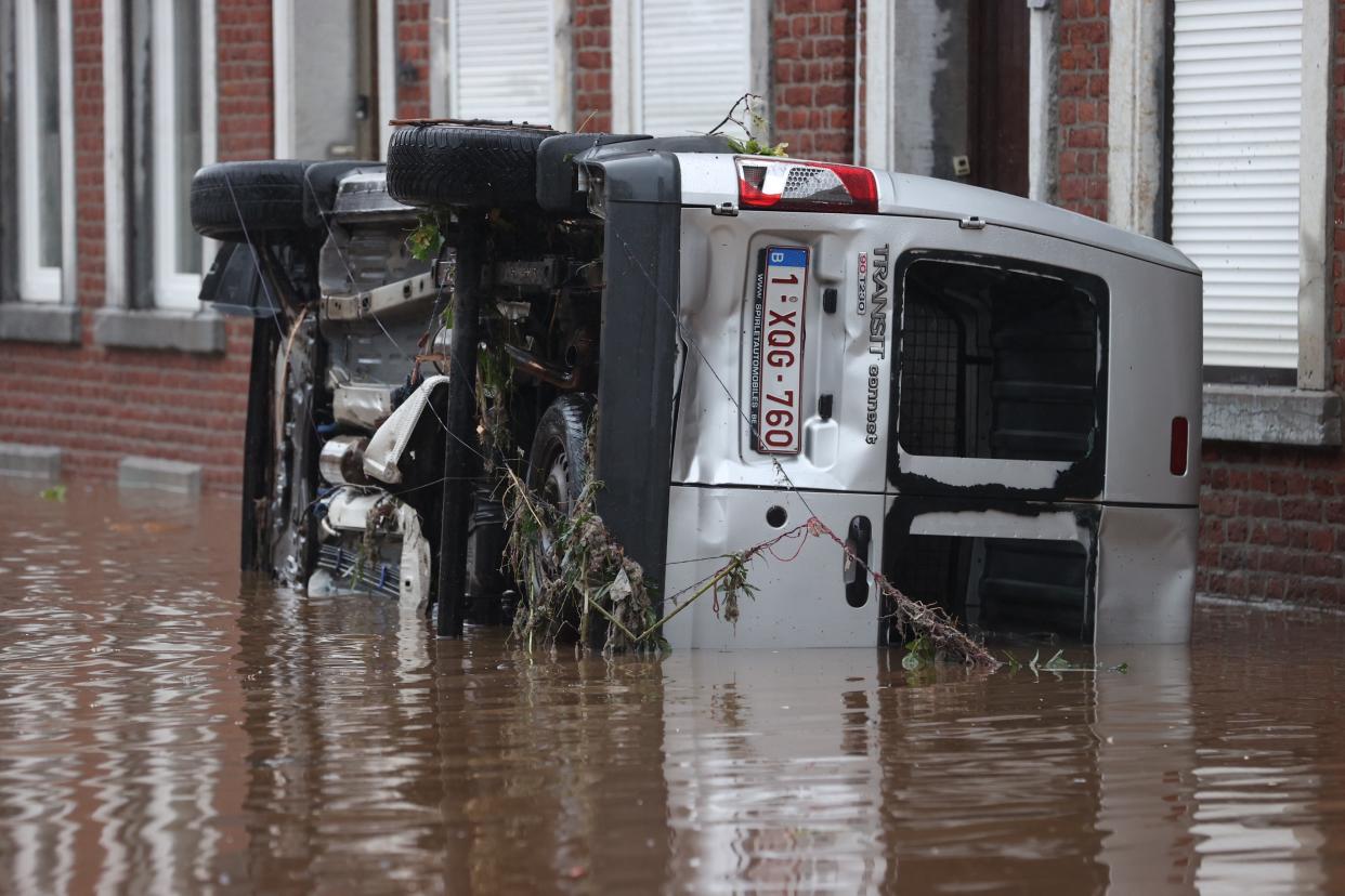 LIEGE, BELGIUM - JULY 15: A damaged car is seen at the flooded site after heavy rain hit Oesival town in province of Liege, Belgium on July 15, 2021. Number of people who lost their lives due to floods caused by the rains that lasted for a few days in the country rose to 6. Because of the heavy rains, a state of emergency was declared in cities such as Liege, Verviers and Spa. In Liege, authorities asked those who do not live in the city to leave the area. Residents near the Meuse River were asked to climb to higher floors. River water level is expected to rise 1.5 meters (Photo by Dursun Aydemir/Anadolu Agency via Getty Images)