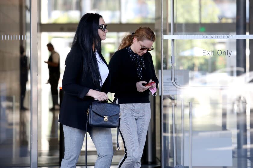 LOS ANGELES, CA - JUNE 25: Marietta (cq) Terabelian (cq), right, of Tarzana, convicted of conspiracy to commit fraud and other federal crimes in a family plot to submit fraudulent applications for emergency government loans to small businesses during the COVID-19 pandemic, exits the Federal Courthouse in downtown on Friday, June 25, 2021 in Los Angeles, CA. Terabelian's sister Gohar Abelian, left, was not accused of wrongdoing. Two Armenian immigrant brothers and their wives in the San Fernando Valley accused of stealing $18 million in COVID-19 disaster relief funds by creating an elaborate network of sham small businesses to secure emergency loans by using stolen identities, forged payrolls and fake tax returns. (Gary Coronado / Los Angeles Times)
