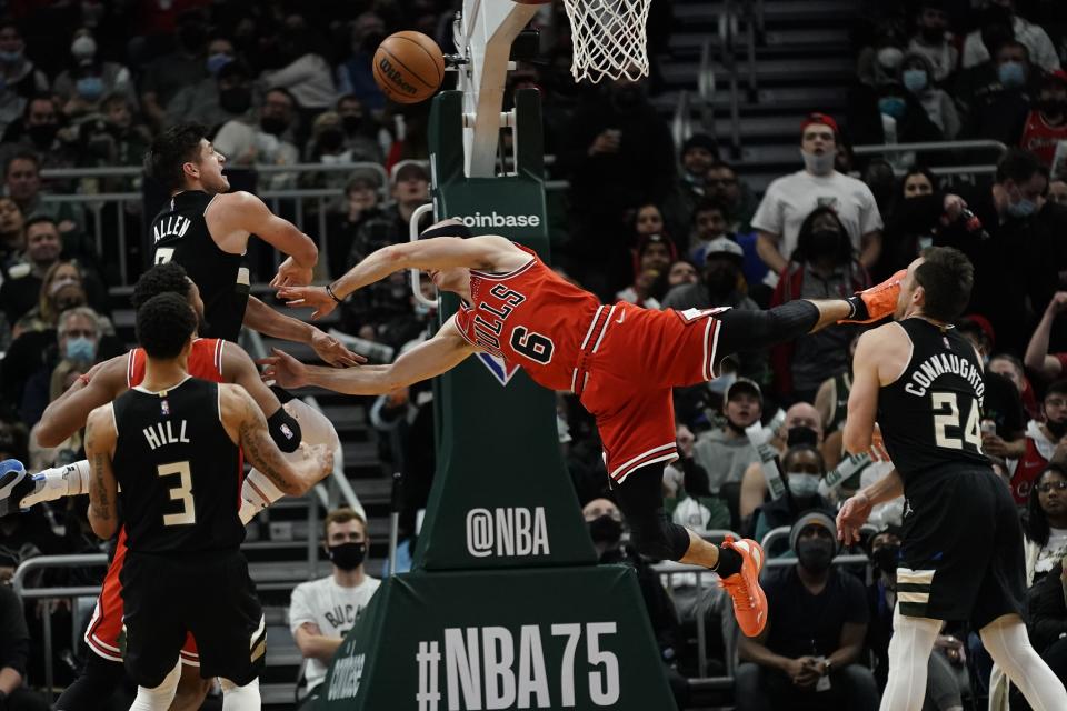 Milwaukee Bucks' Grayson Allen fouls Chicago Bulls' Alex Caruso during the second half of an NBA basketball game Friday, Jan. 21, 2022, in Milwaukee. The Bucks won 94-90. (AP Photo/Morry Gash)