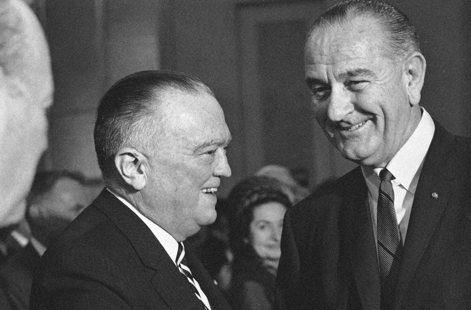 President Lyndon Johnson talks with J. Edgar Hoover, FBI director, at the swearing in of Ramsey Clark in Washington on March 10, 1967 as Attorney General.