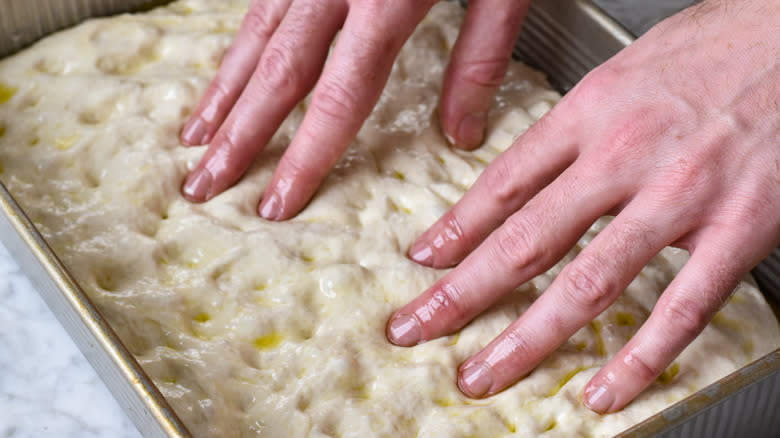 stretching bread dough with fingers