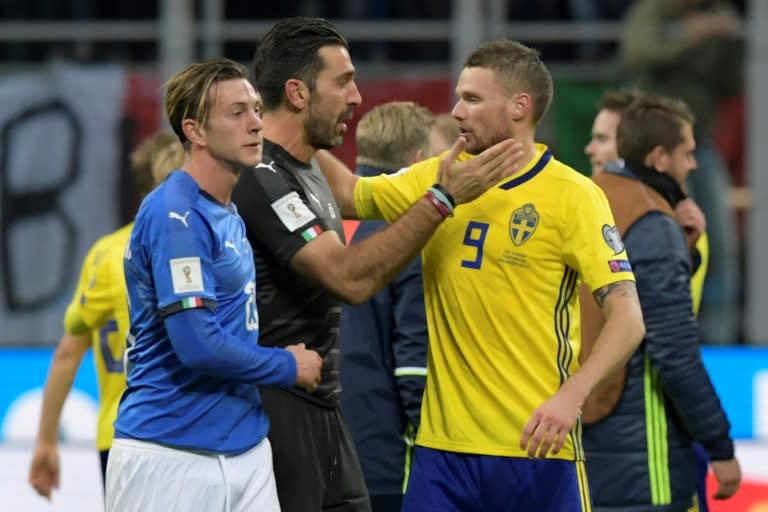 Italy's goalkeeper and captain Gianluigi Buffon (C) congratulates Sweden's Marcus Berg at the end of their FIFA 2018 World Cup qualification 2nd leg match, at the San Siro stadium in Milan, on November 13, 2017