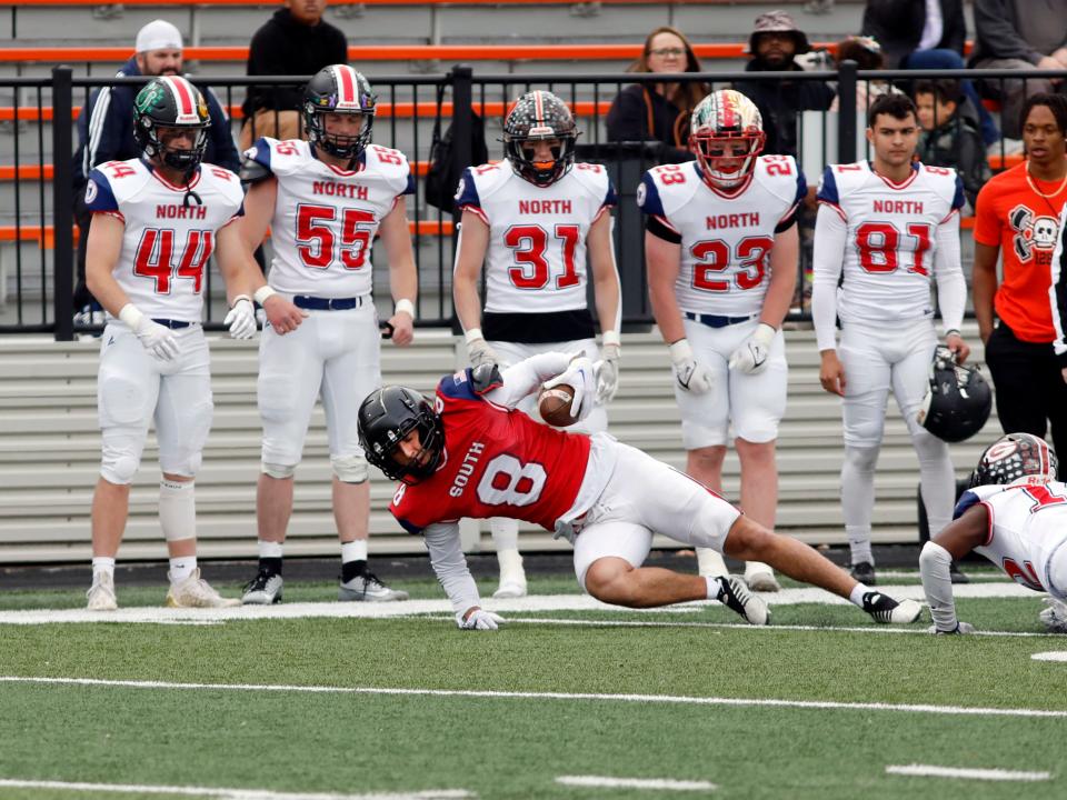 Lukas Ratliff, of New Lexington, lunges for extra yards after catching a pass during the Ohio North-South Football Classic on Saturday at Paul Brown Stadium in Massillon. Ratliff, a Marietta commit, played on the South team in the Division IV-VII game.