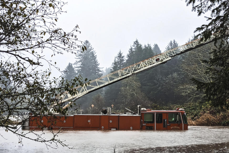 In this photo provided by the Lincoln County Sheriff's Department, a fire engine is surrounded by rising waters in Otis, Ore., Friday, Nov. 12, 2021. The U.S. Coast Guard has used two helicopters to rescue about 50 people from rising waters at an RV park on the Oregon Coast Friday as heavy rains in the Pacific Northwest prompted warnings of floods and landslides. (Sgt. Jack Dunteman/Lincoln County Sheriff's Department via AP)