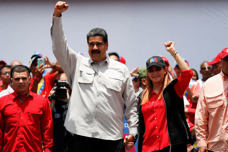 Venezuela's President Nicolas Maduro greets supporters next to his wife Cilia Flores during a campaign rally in Charallave, Venezuela May 15, 2018. REUTERS/Carlos Garcia Rawlins