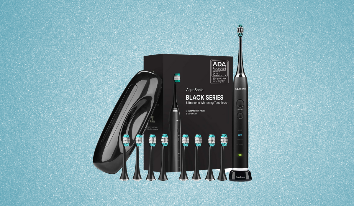 A wireless black toothbrush with 8 brush head replacements, black carrying case, and black box