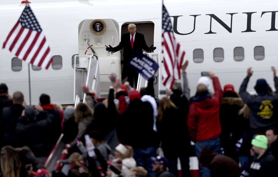 FILE - President Donald Trump reacts to the crowd while he exits Air Force One as he arrives for a campaign rally at Reading Regional Airport, Oct. 31, 2020, in Reading, Pa. Trump adhered to rules on reimbursements for campaign travel during his failed bid for a second term. However, he drew scrutiny for blurring the lines in other ways. For example, he used Air Force One and Marine One as backdrops for political events, and he would direct the plane to be flown over his rallies to energize supporters. (AP Photo/Michael Perez, File)