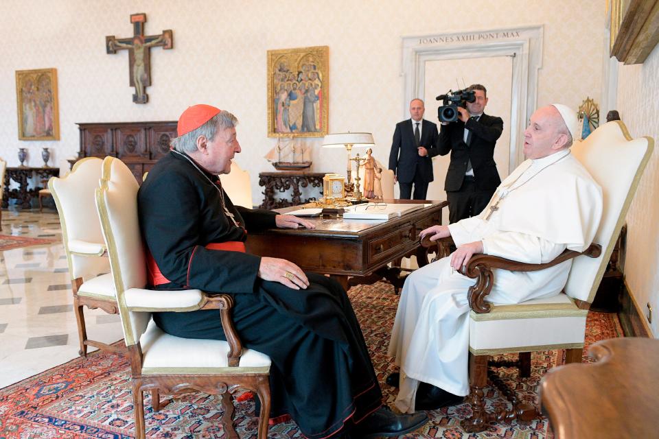 Pope Francis, right, sits at a table with Cardinal George Pell on the occasion of their private meeting at the Vatican in 2020. The Pope warmly welcomed Cardinal for a private audience in the Apostolic Palace after the cardinal's sex abuse conviction and acquittal in Australia. Pell died Jan. 10.