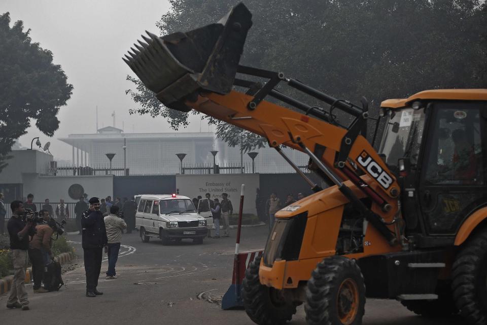 A bulldozer removes the security barriers in front of the U.S. embassy in New Delhi