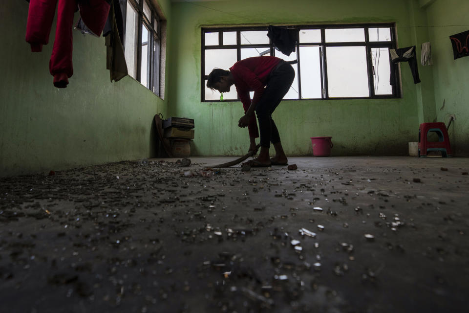 A worker sweeps debris off the floor of a restaurant which was partially vandalized during Monday's violence in Sohna near Nuh in Haryana state, India, Tuesday, Aug., 1, 2023. Deadly clashes between Hindus and Muslims began in the area Monday afternoon during a religious procession by a Hindu nationalist group forcing Indian authorities to impose a curfew and suspend Internet services. (AP Photo/Altaf Qadri)