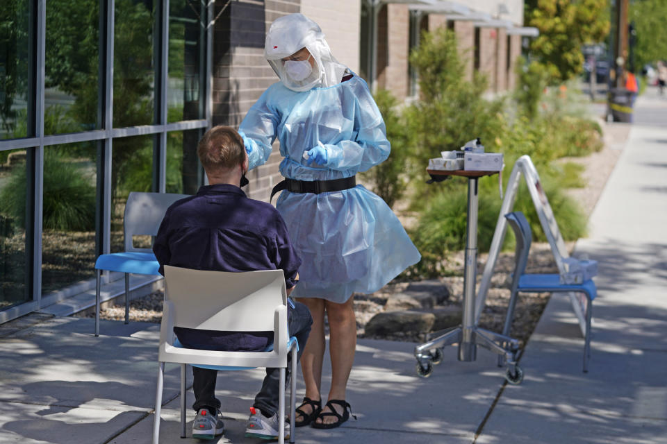 Image: A person receives a Covid-19 test outside the Salt Lake County Health Department on July 22, 2022. (Rick Bowmer / AP)