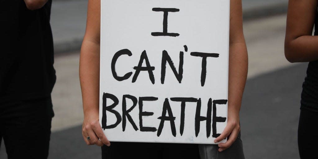 A demonstrator holds a banner reading "I Can't Breathe" in Washington D.C. on May 29, 2020.