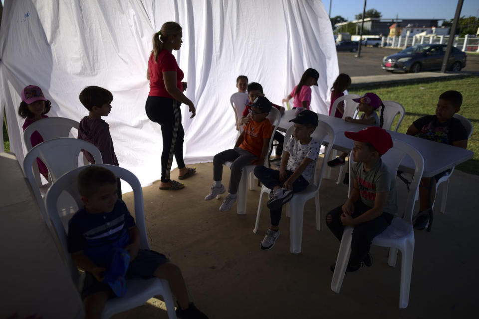 Una maestra da una clase de kindergarten en la glorieta de un parque deportivo municipal de Santa Isabel, Puerto Rico, el 4 de febrero del 2020. Casi dos tercios de las escuelas públicas de Puerto Rico permanecen cerradas desde el terremoto que azotó la isla a principios de enero. (AP Photo/Carlos Giusti)