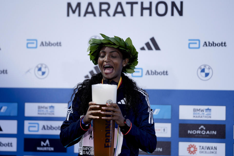 Ethiopia's Tigist Assefa celebrates after winning the women's division of the Berlin Marathon and a new world record, in Berlin, Germany, Sunday, Sept. 24, 2023. (AP Photo/Markus Schreiber)