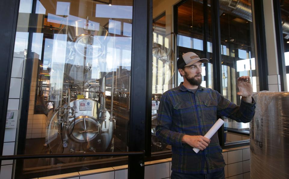 Andy Joynt describes the brewing process in Big Grove Brewery's fermentation room, a unique feature of its Cedar Rapids location, on Thursday, Dec. 7, 2023 during a media tour.