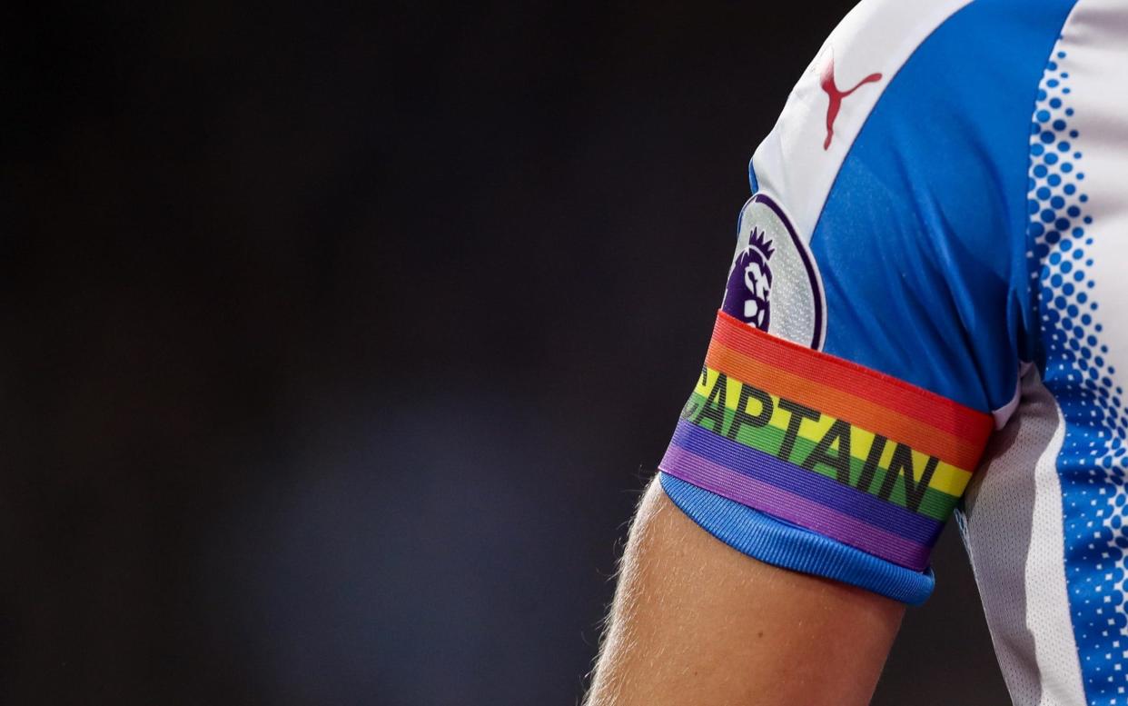 Tommy Smith of Huddersfield Town wears a rainbow captain's armband in support of LGBT during the Premier League match between Huddersfield Town and Manchester City - Getty Images Europe