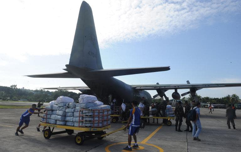 Soldiers unload relief supplies from a C-130 plane at Bohol airport in the central Philippines, on October 18, 2013