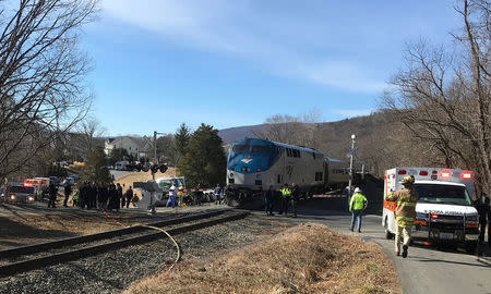 FILE PHOTO: Emergency first responders work at the scene of the crash where an Amtrak passenger train carrying Republican members of the U.S. Congress from Washington to a retreat in West Virginia collided with a garbage truck in Crozet, Virginia, U.S. January 31, 2018. Justin Ide/Crozet Volunteer Fire Department/Handout via REUTERS