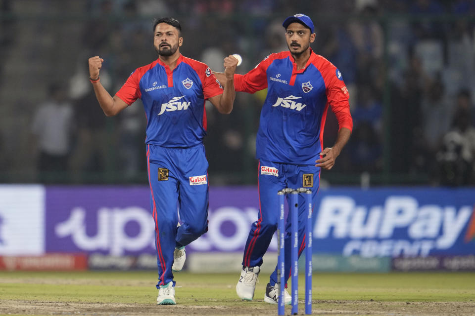 Delhi Capitals' Mukesh Kumar, left, and Axar Patel celebrate the dismissal of Mumbai Indians' Suryakumar Yadav during the Indian Premier League (IPL) match between Delhi Capitals and Mumbai Indians in New Delhi, India, Tuesday, April 11, 2023. (AP Photo/Manish Swarup)