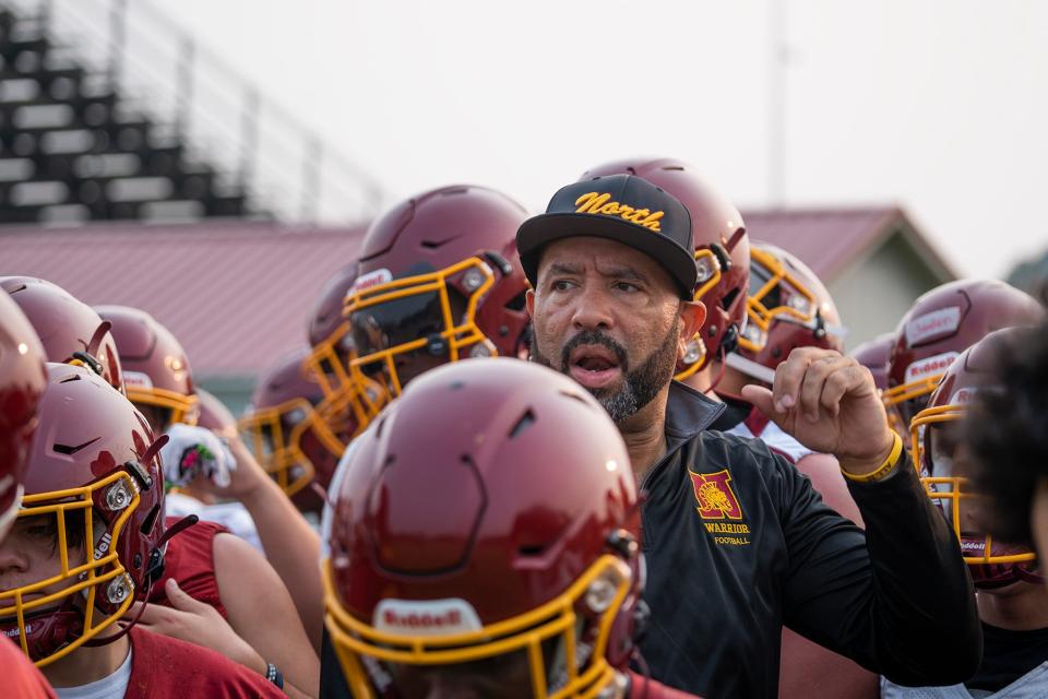 First-year Westerville North football coach Stanley Jackson Sr. addresses his players at Monday's workout.