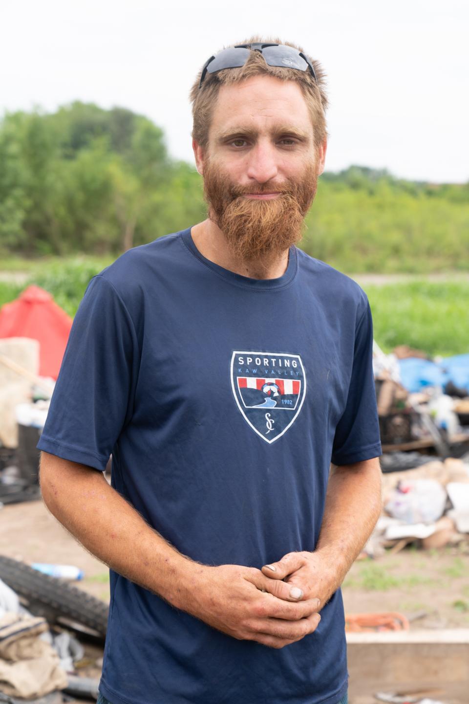 Cody Bartley poses Friday at the camp where he lives in the "Tent City" community east of the Topeka Rescue Mission.