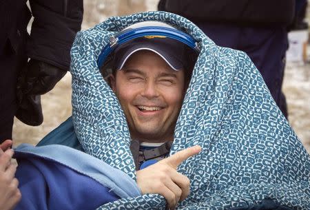 International Space Station (ISS) crew member Reid Wiseman of the U.S. rests after landing in a remote area near the town of Arkalyk in northern Kazakhstan, November 10, 2014. REUTERS/Shamil Zhumatov