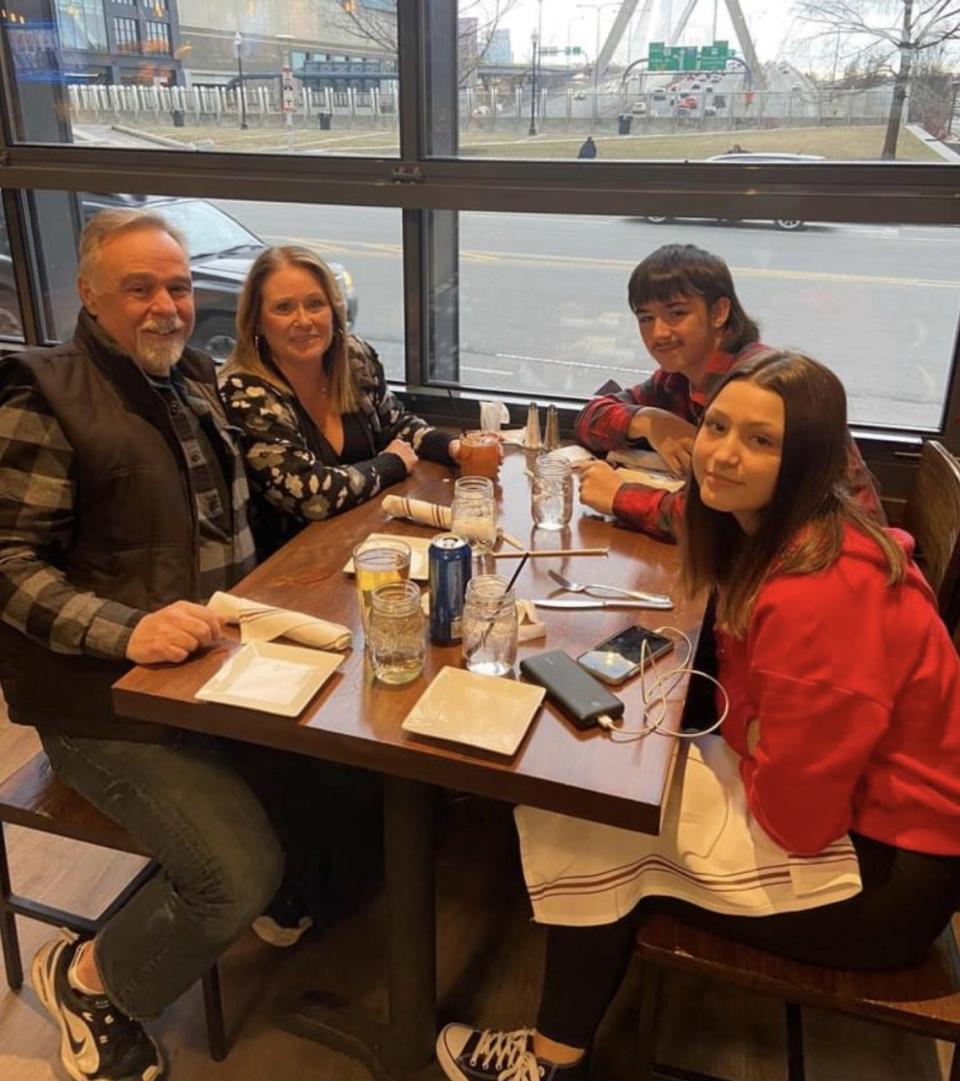 Cameron Audet enjoys a meal with his sister Jada, grandma Victoria Crowley and Robert Banks at a restaurant in Boston.