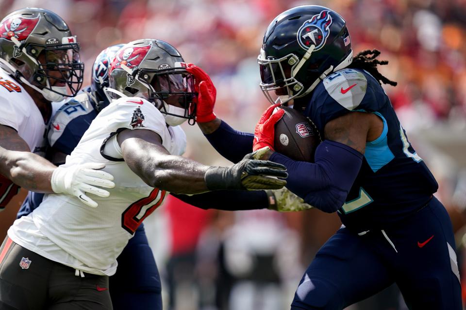Tennessee Titans running back Derrick Henry (22) runs the ball towards Tampa Bay Buccaneers linebacker Yaya Diaby (0) during the first quarter at Raymond James Stadium in Tampa, Fla., Sunday, Nov. 12, 2023.