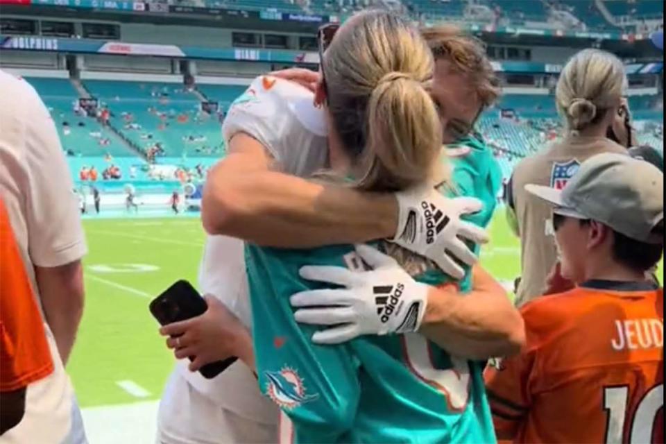 <p>alixearle/TikTok</p> Alix Earle hugs Braxton Berrios as she supports him at Miami Dolphins game