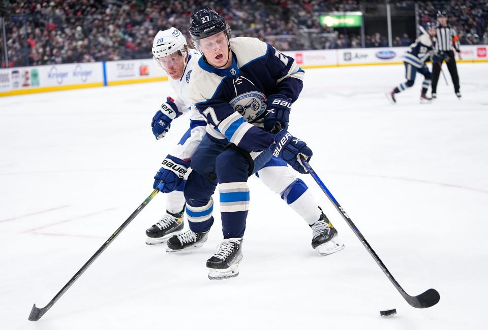 Blue Jackets defenseman Adam Boqvist steers the puck around Tampa Bay center Riley Nash on Jan. 4.