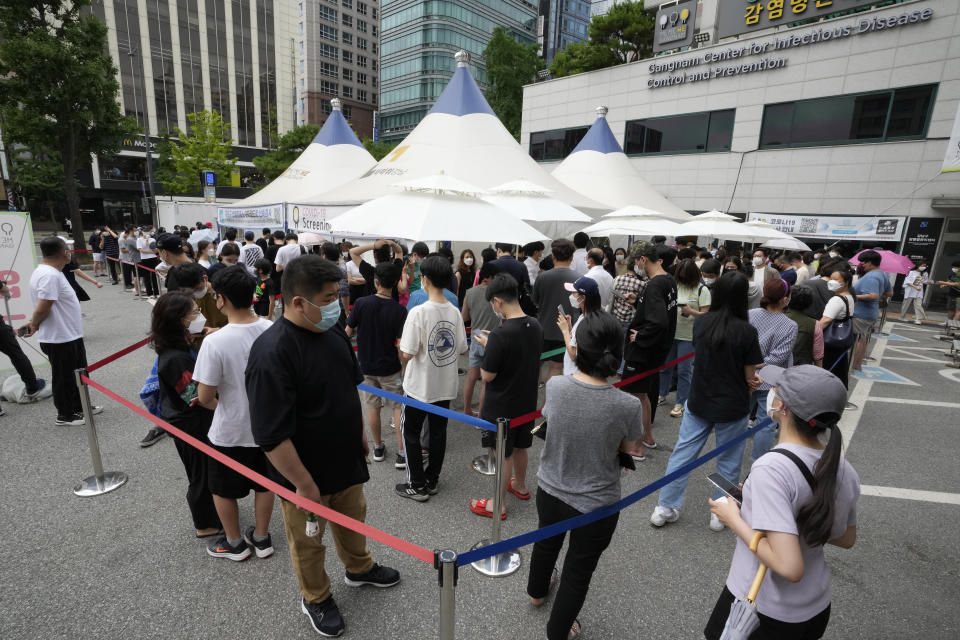 In this July 9, 2021, file photo, people queue in line to wait for the coronavirus testing at a Public Health Center in Seoul, South Korea. South Korea will enforce its strongest social distancing restrictions in the greater capital area starting next week as it wrestles with what appears to be the worst wave of the coronavirus since the start of the pandemic. (AP Photo/Ahn Young-joon, File)