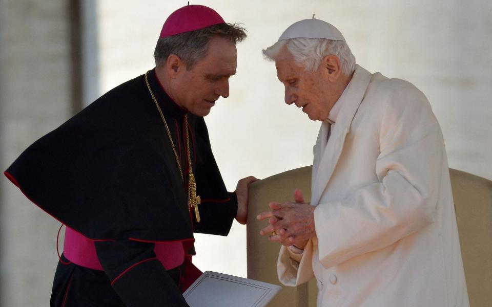 A file photo from 2013 showing then Pope Benedict XVI leaving the altar with his secretary Georg Gaenswein in St Peter's Square - AFP/A file photo from 2013 showing then Pope Benedict XVI leaving the altar with his secretary Georg Gaenswein in St Peter's Square