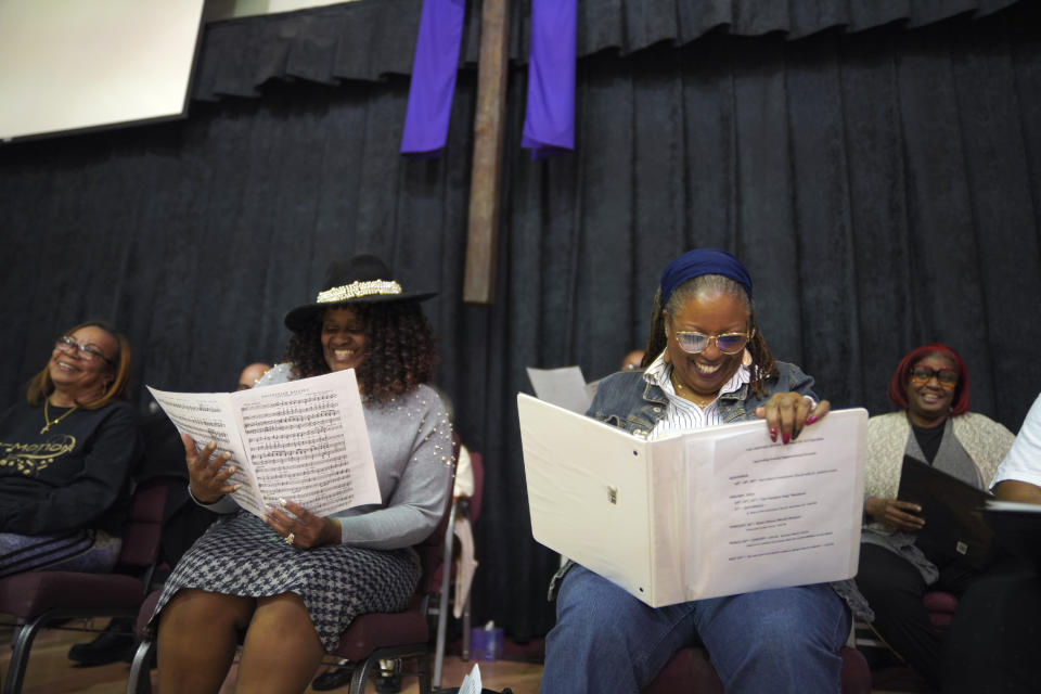 Members of The Heritage Gospel Chorale of Pittsburgh, from left, Marleen Tucker, L. Twila Davis, and Jocelyn Scott, laugh between songs during a rehearsal for an upcoming concert honoring the late gospel composer, musician and publisher, Charles Henry Pace, on Monday, March 6, 2023, at Bethany Baptist Church in Pittsburgh. The concert will be held on Saturday, March 25 at Ebenezer Baptist Church in Pittsburgh's Historic Hill District. (AP Photo/Jessie Wardarski)