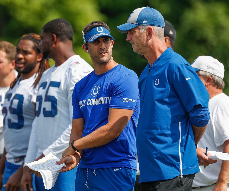 Indianapolis Colts head coach Frank Reich talks to offensive coordinator Nick Sirianni, left, during their preseason training camp at Grand Park in Westfield on Saturday, August 11, 2018. 