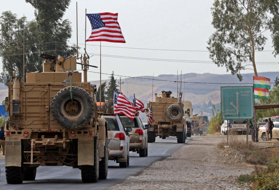 A convoy of US military vehicles arrives near the Iraqi Kurdish town of Bardarash in the Dohuk governorate after withdrawing from northern Syria on October 21, 2019.