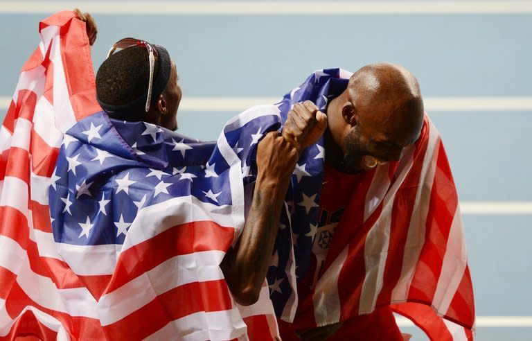 US athlete LaShawn Merritt (R) celebrates with his compatriot Tony McQuay after winning first and second places respectively in the men's 400 metres final at the 2013 IAAF World Championships at the Luzhniki stadium in Moscow on August 13, 2013