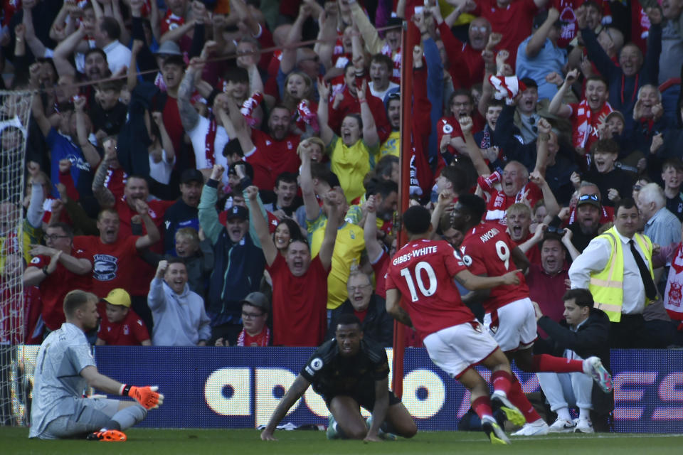 Nottingham Forest's Taiwo Awoniyi, right, celebrates with teammates after scoring his sides first goal during the English Premier League soccer match between Nottingham Forest and Arsenal at City ground in Nottingham, England, Saturday, May 20, 2023. (AP Photo/Rui Vieira)