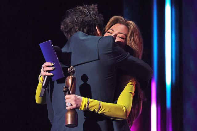 <p>David M. Benett/Max Cisotti/Dave Benett/Getty</p> Harry Styles hugging Shania Twain at the BRIT Awards in 2023