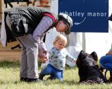<p>Princess Anne and her granddaughter, Mia Tindall, meet a dog at the Whatley Manor International Horse Trials.</p>