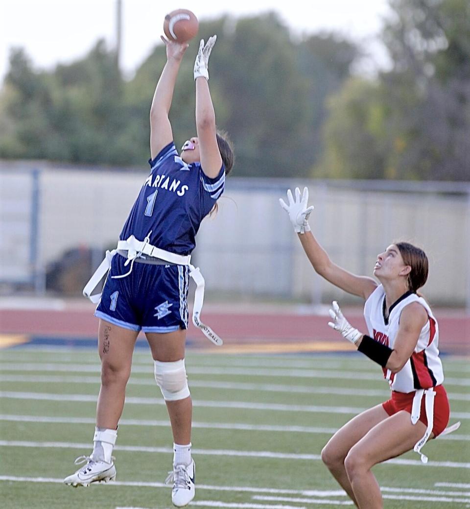 Sylmar's Mia Ceja makes a leaping catch in front of Verdugo Hills defensive back Lauren Brink in the Dons' 29-20 victory.