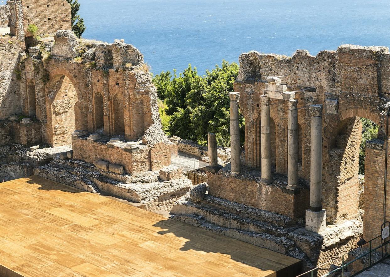 The remnants of a Greek theater in Sicily. <a href="https://www.gettyimages.com/detail/photo/panoramic-sights-of-the-beautiful-greek-theater-of-royalty-free-image/1345579639?phrase=++aulos+player+greek+theater&adppopup=true" rel="nofollow noopener" target="_blank" data-ylk="slk:Fausto Riolo/Getty Images;elm:context_link;itc:0;sec:content-canvas" class="link ">Fausto Riolo/Getty Images</a>