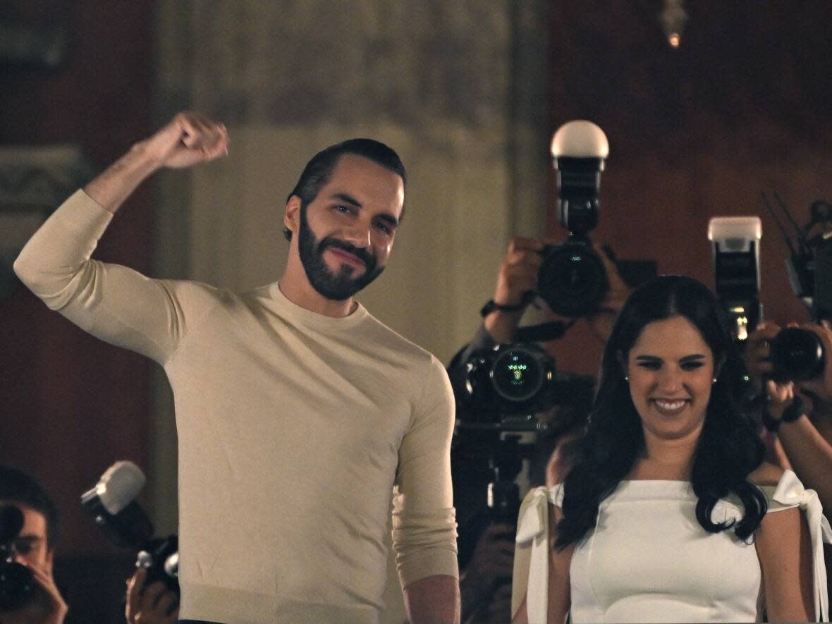 El Salvadoran President Nayib Bukele greets supporters next to his wife Gabriela Rodriguez after the presidential and legislative elections, in San Salvador on Sunday night. (Yuri Cortez/AFP/Getty Images - image credit)